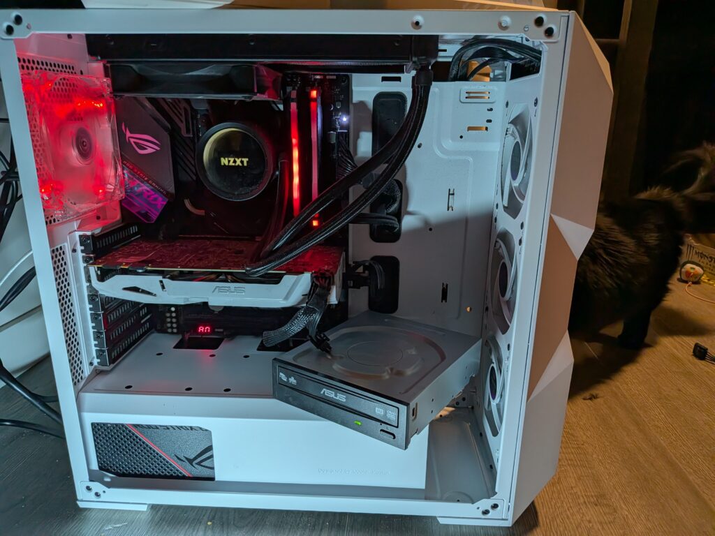 Open computer tower case with disk drive connected but not installed