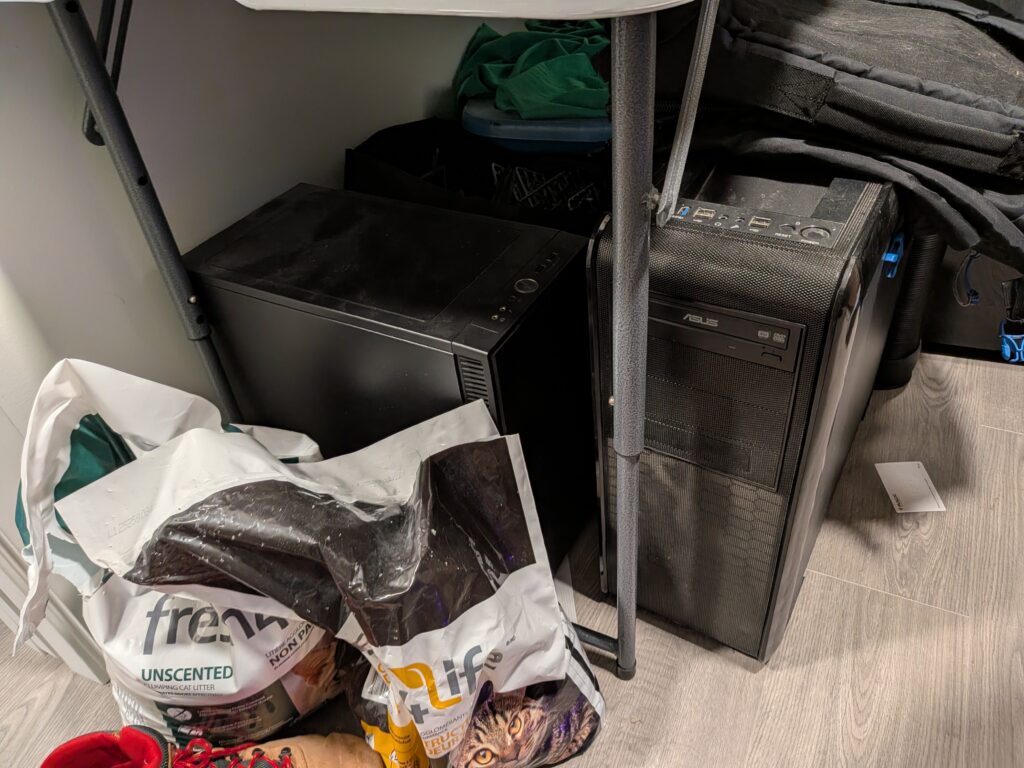 Three computer towers stored under a table